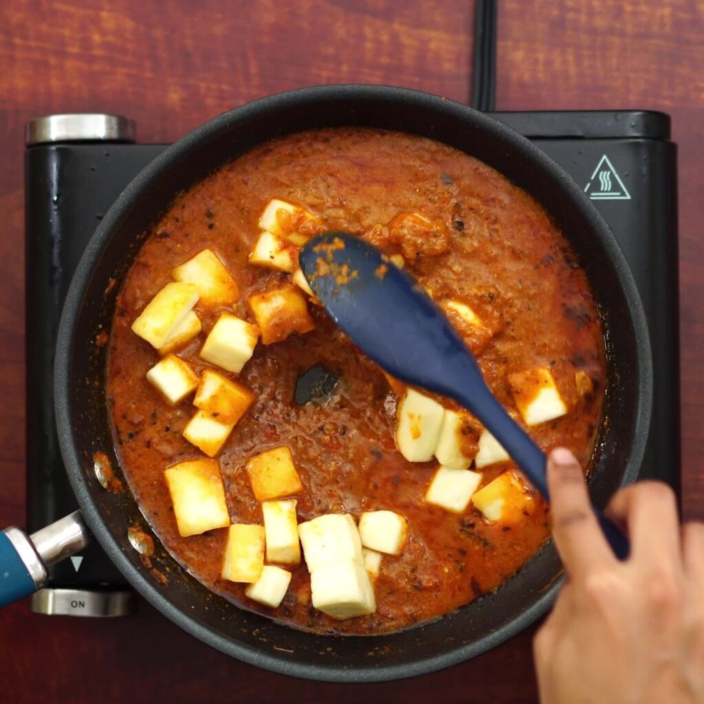 adding fried paneer and mixing