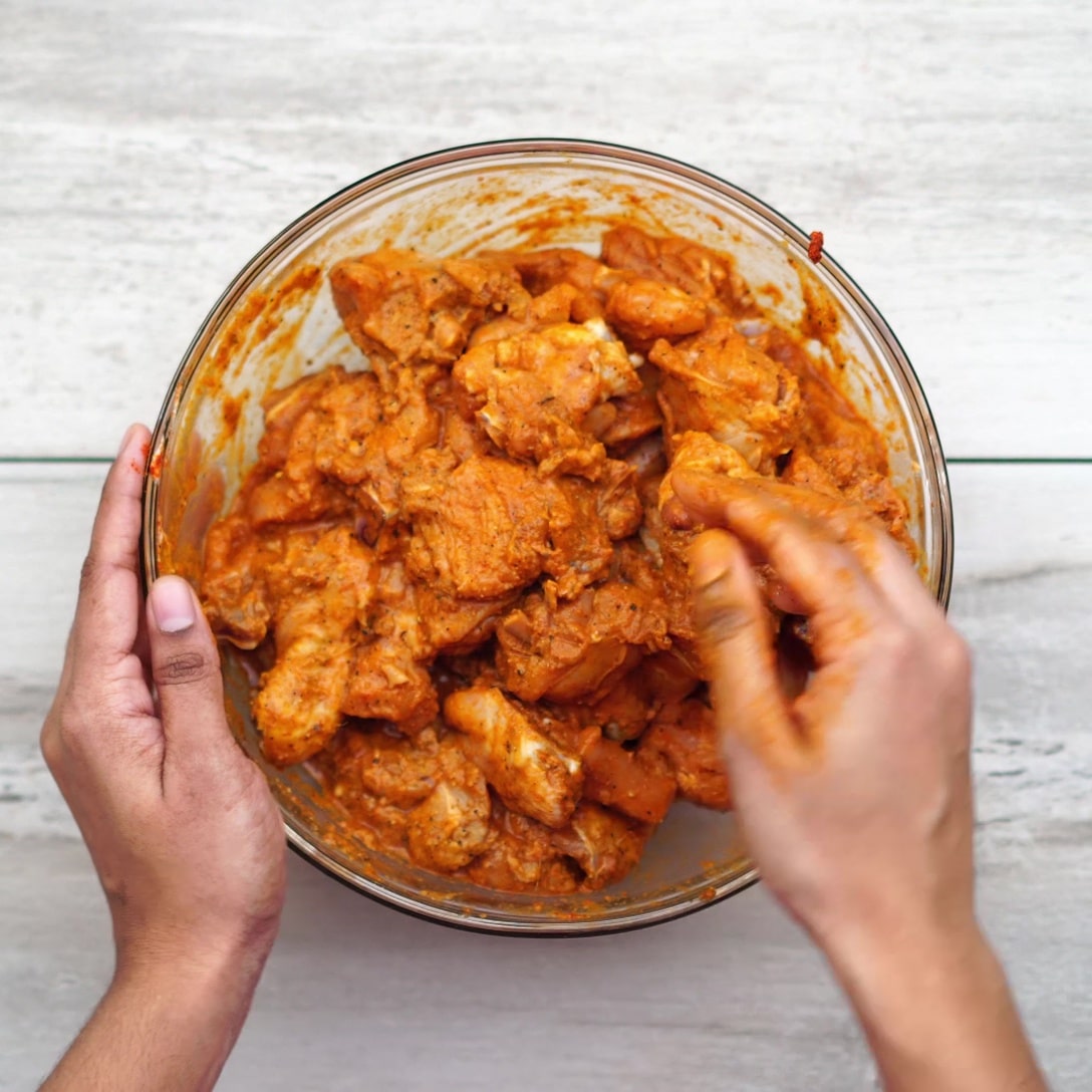 mixing chicken and masala
