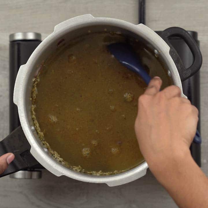 Adding water and stirring the rice