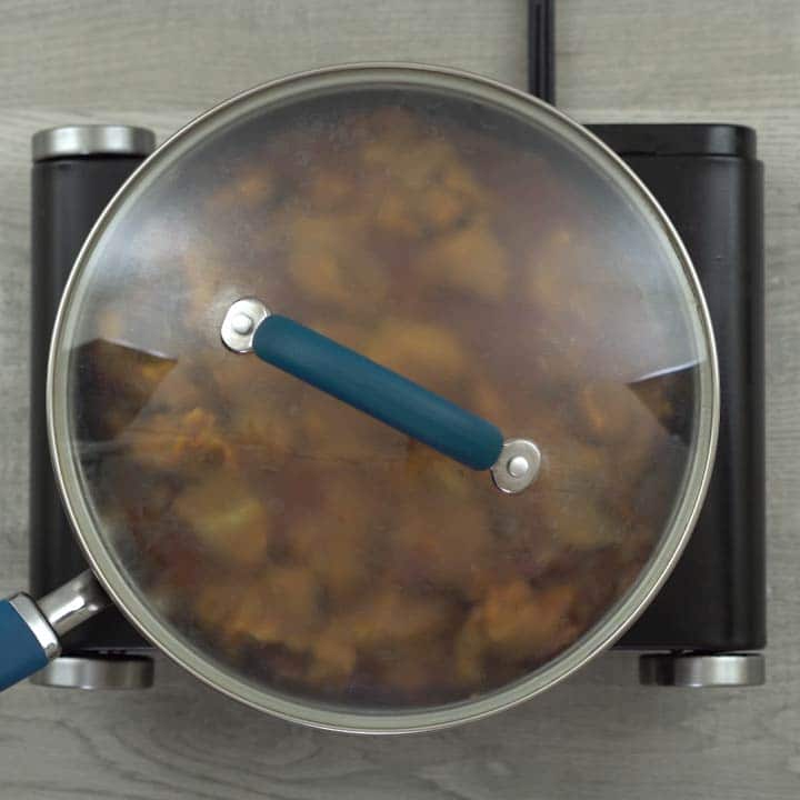 mutton cooking in a pan with masala
