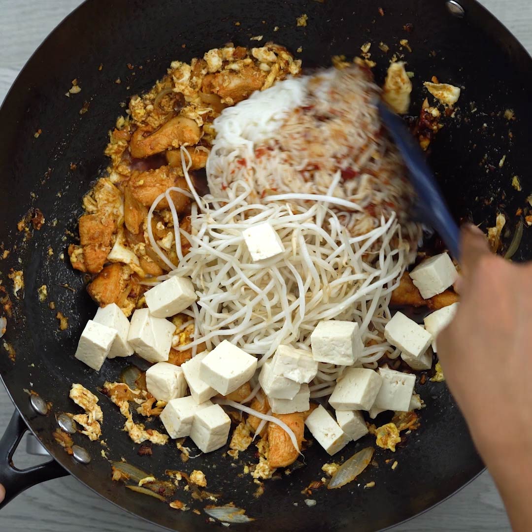 tofu, noodles, bean sprouts added to the wok