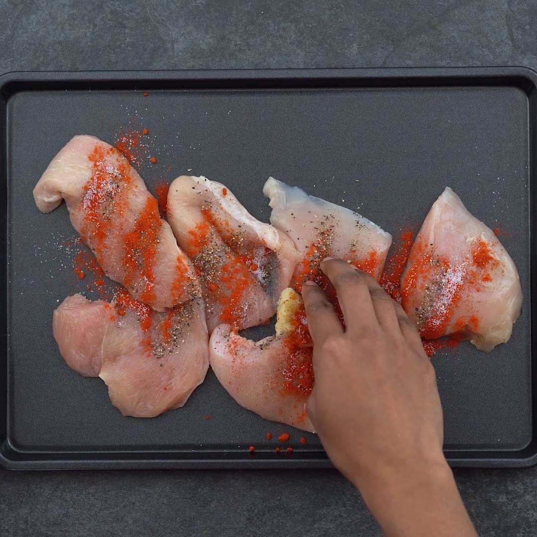 marinating the chicken with seasoning