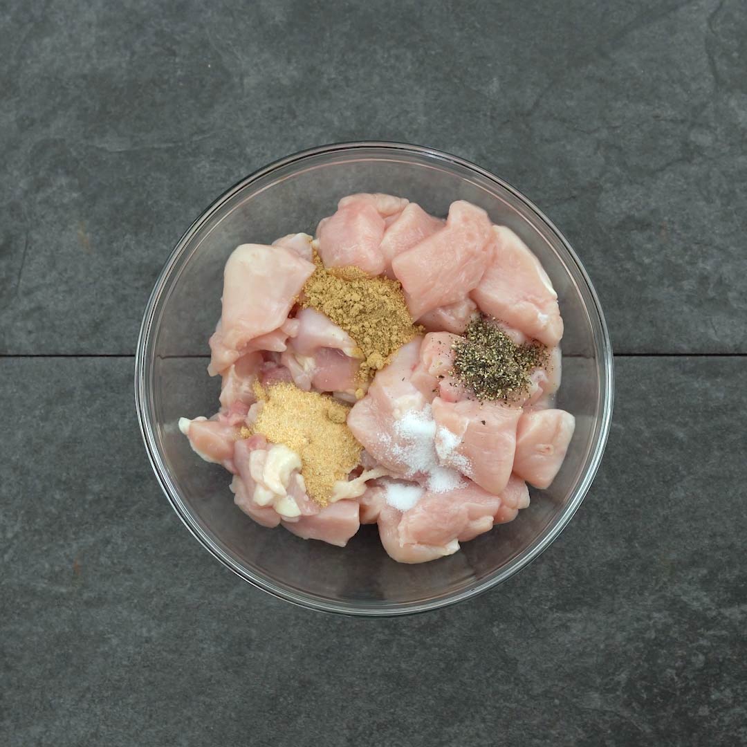 chicken with seasoning powders in a bowl