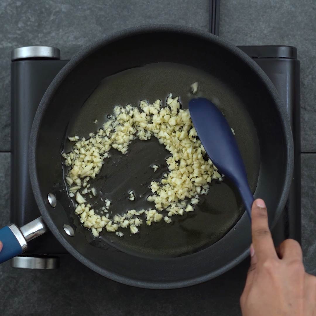 sauteing the garlic in a pan