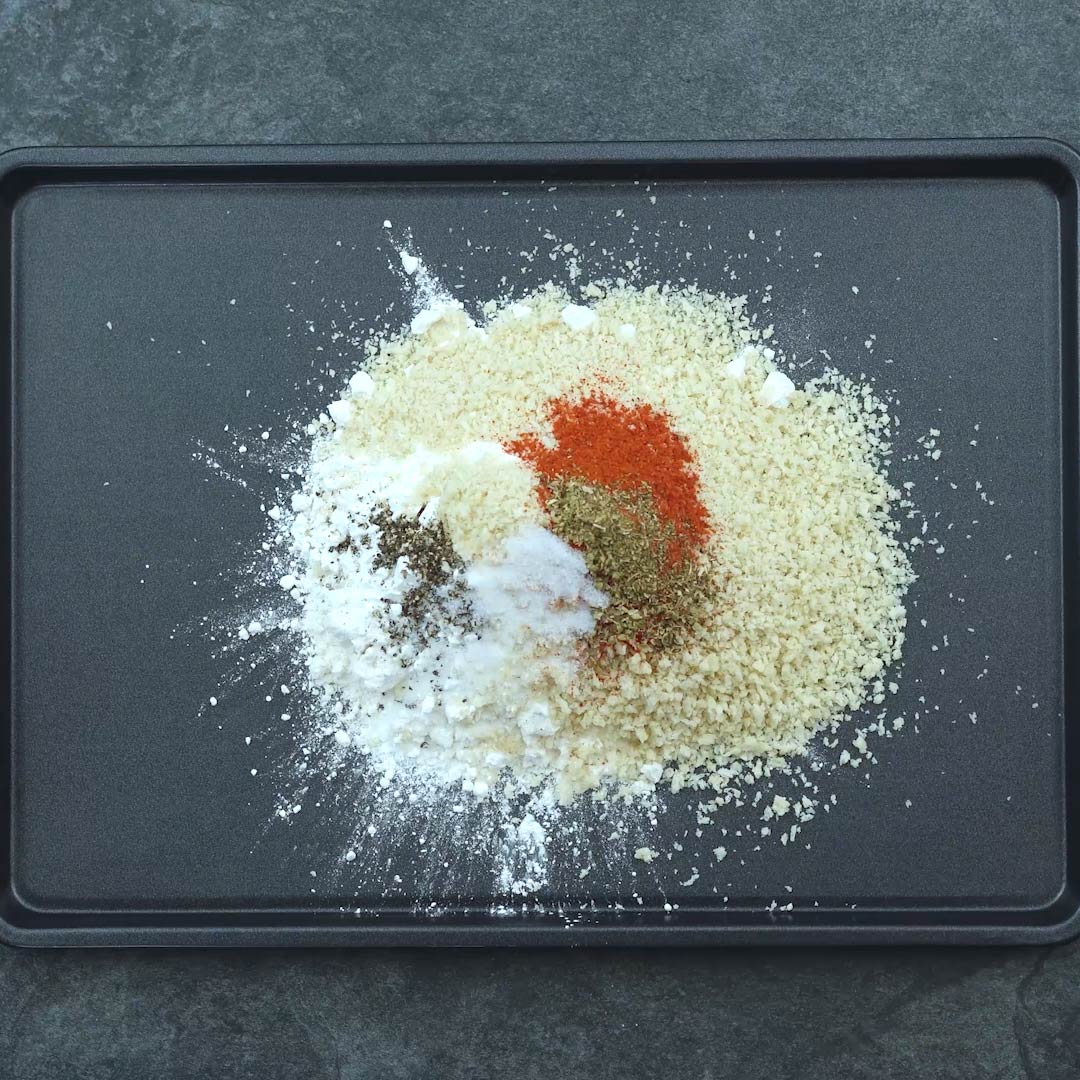 flour and panko breadcrumb with spice powders in a tray