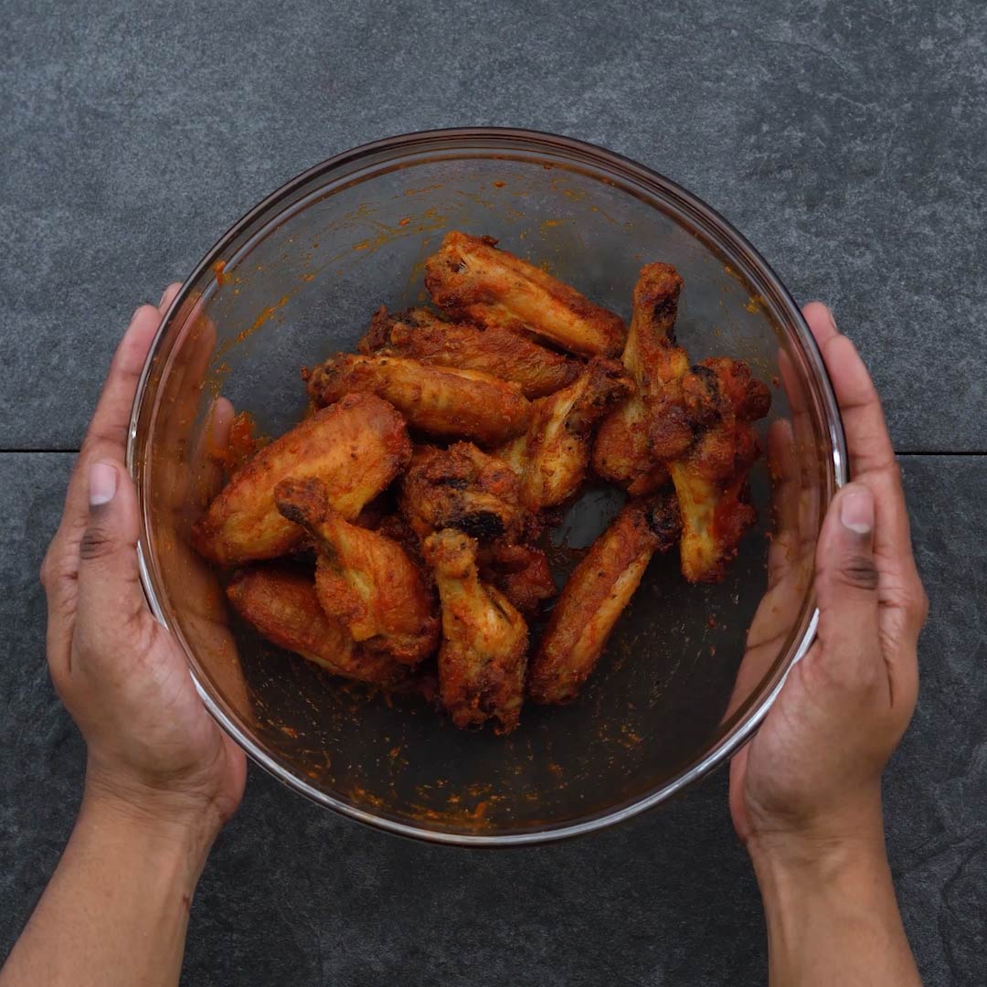Hot sauce tossed air fried chicken wings