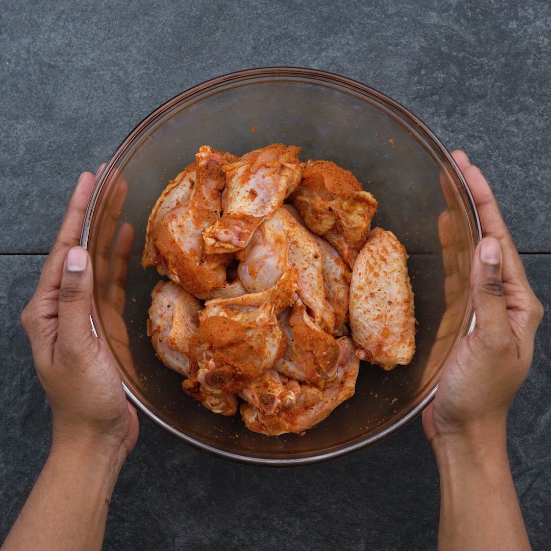 Dry rub marinated chicken wings in a bowl