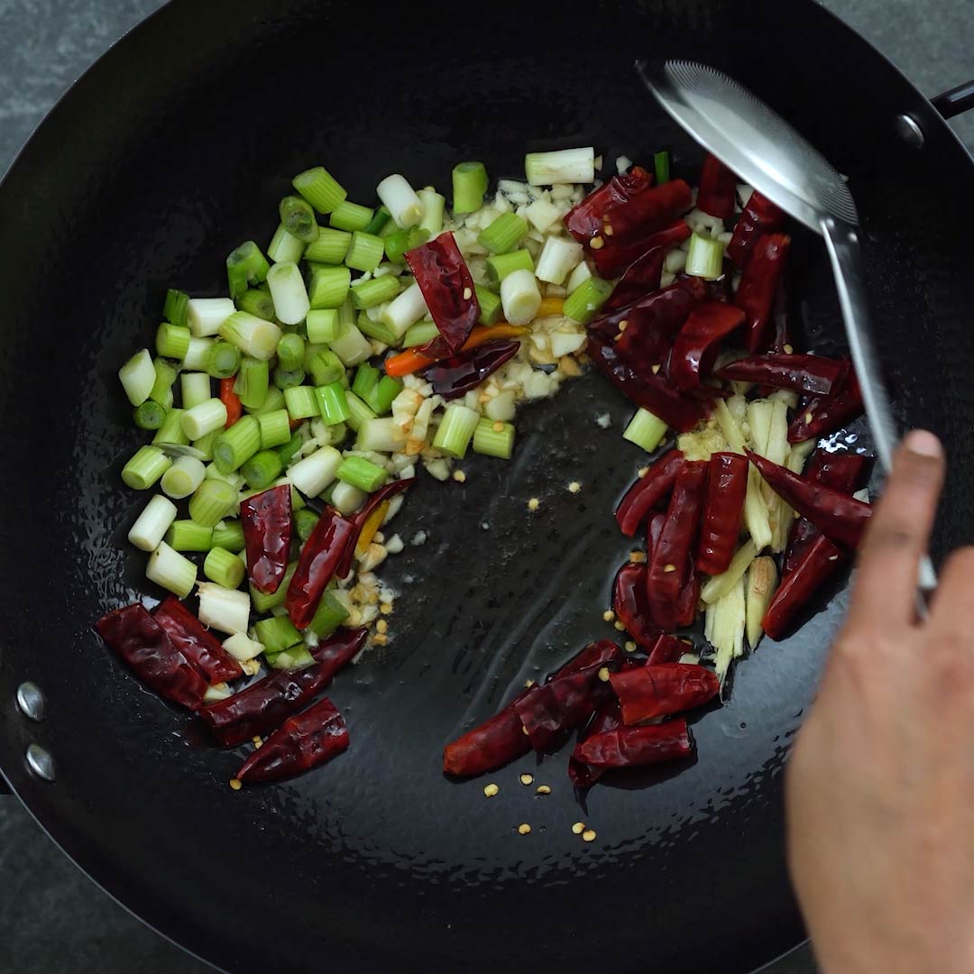 Stir frying the aromatic in a wok
