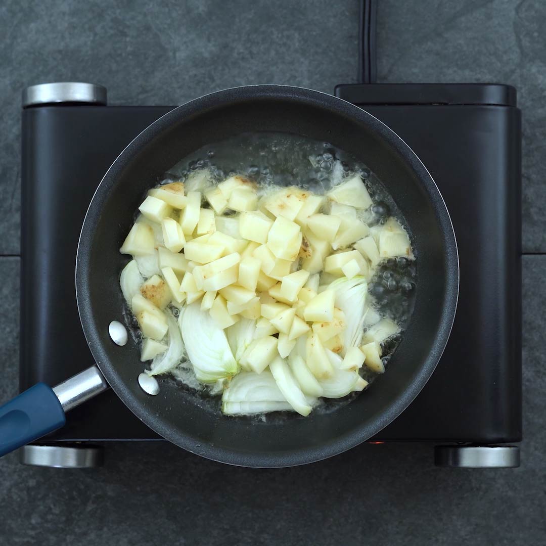 onion and potatoes frying in oil