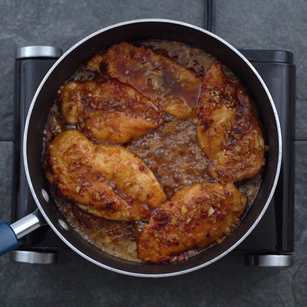 Honey Garlic coated chicken breast in a pan