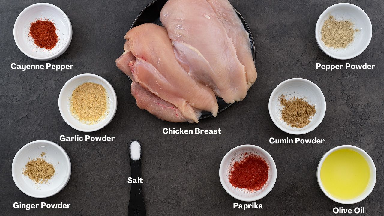 Oven baked chicken breast ingredients placed on a gray table