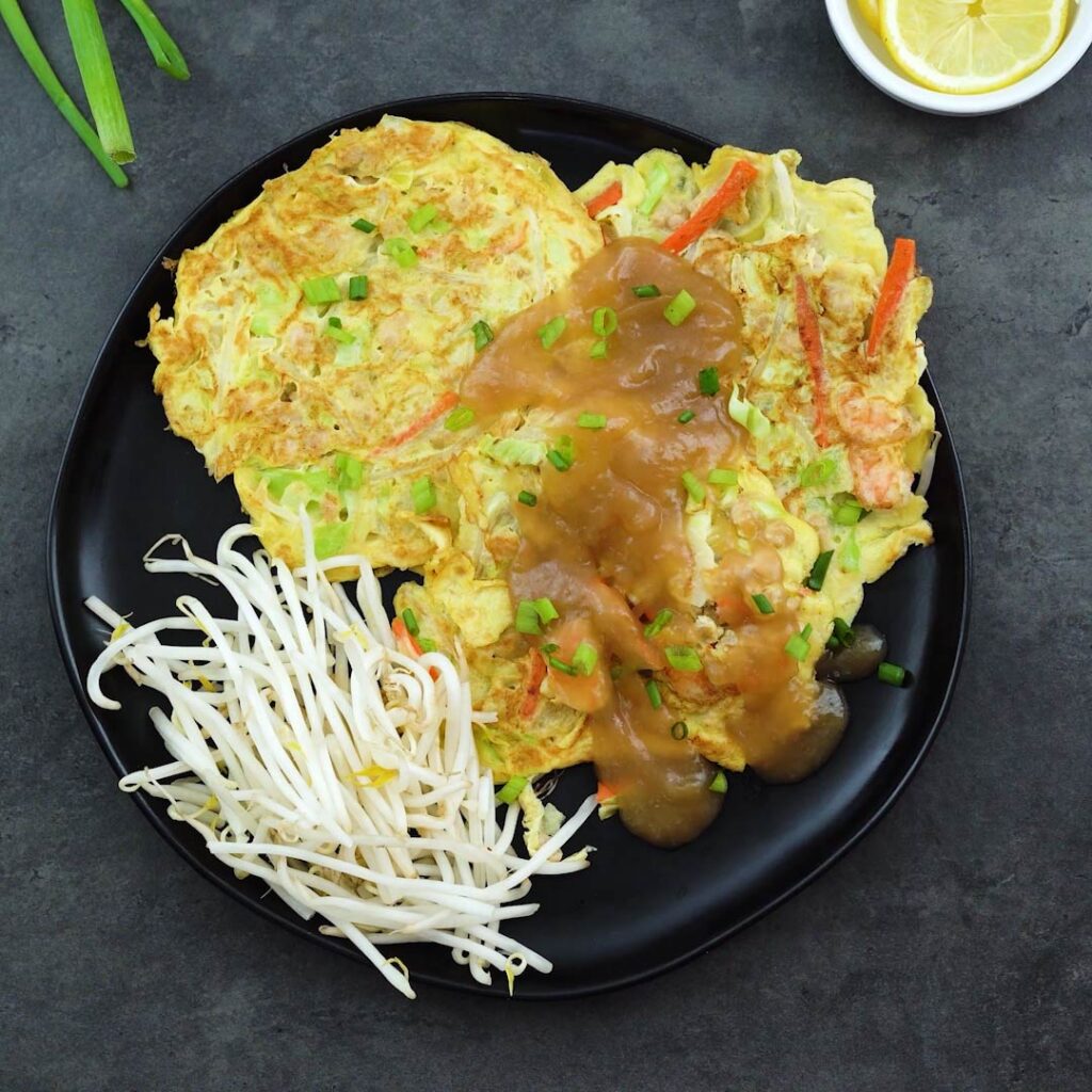 Egg Foo Young served in a plate with bean sprouts