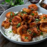 Honey Garlic Shrimp in a white bowl placed on a gray table