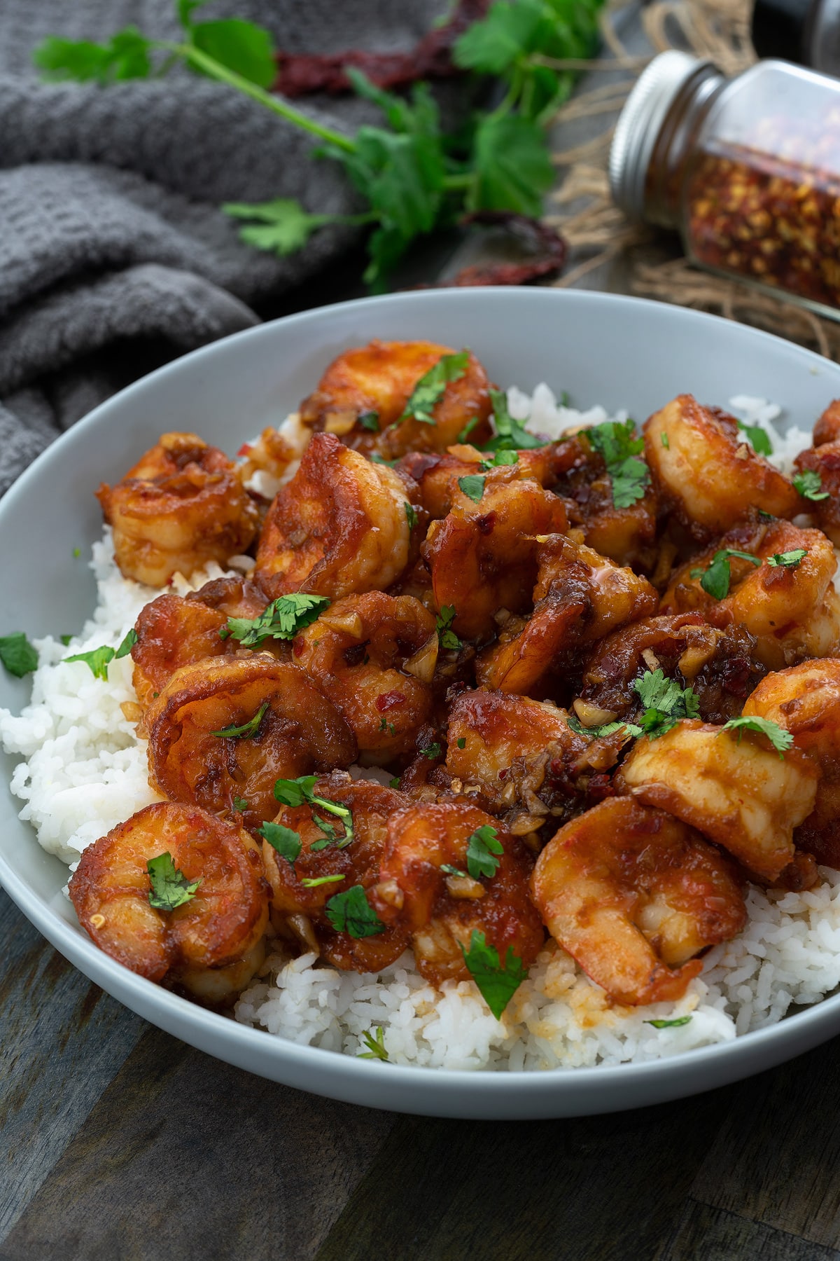 Honey Garlic Shrimp in a white bowl placed on a grey table