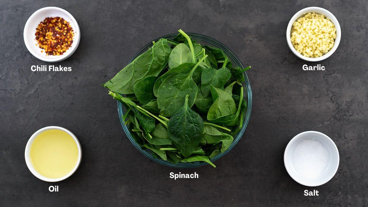 Sauteed Spinach recipe ingredients on a gray table