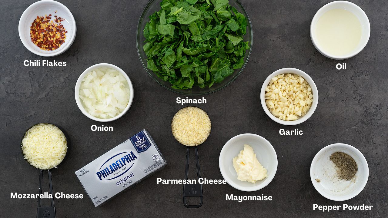 Filling ingredients for Spinach stuffed chicken breast placed on a grey table